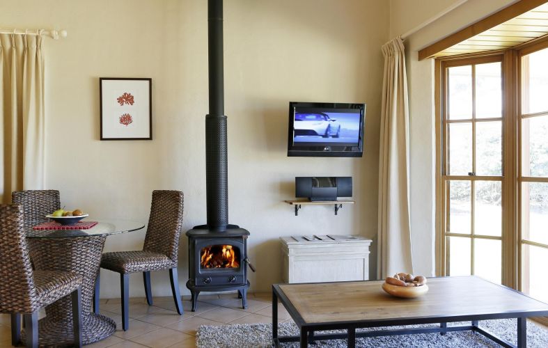 Berenbell Vineyard Retreat - Living area in Cottage showing pot belly fireplace
