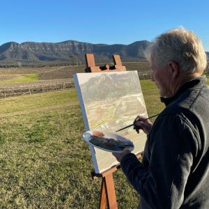 Artist painting the Brokenback Ranges